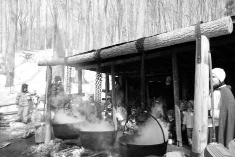 Traditional method of boiling sap in cast iron pots over an open fire